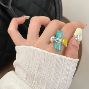 Handmade wire-wrapped natural stone ring with colorful beads for women, stylish summer jewelry detail.