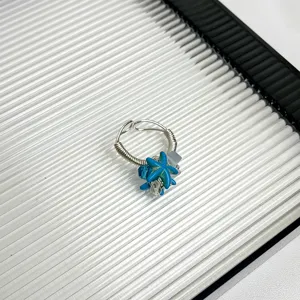 Handmade blue starfish wire wrapped ring detail view, summer style niche fashion jewelry piece.