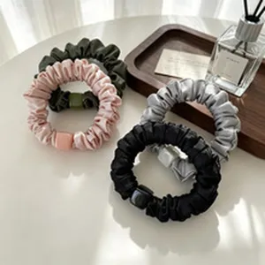 Detail showing elegant silk scrunchies hair ties with square bead in assorted colors