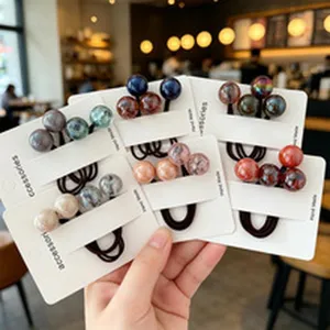 Detailed view of colorful marbled acrylic bead hair ties on display cards
