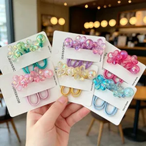 Close-up of colorful acrylic flower elastic hair ties on white display cards in a cafe