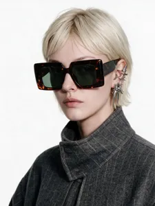 Macro view of vintage tortoiseshell square sunglasses and silver spike ear cuffs