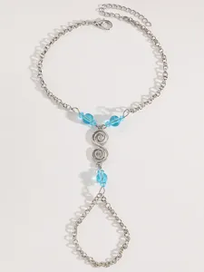 Detailed view of silver bohemian chain hand harness bracelet with blue crystal beads