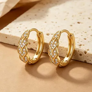 Close-up of elegant gold-plated s925 silver hoop earrings with braided zircon detail.