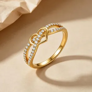 Elegant gold plated ring featuring interlocking hearts and shimmering cubic zirconia stones.