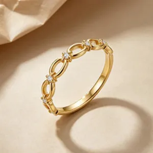 Detailed close-up view of elegant gold chain-link ring with small cubic zirconia stones