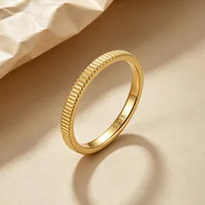 Detail of a minimalist gold-plated S925 sterling silver ring with ribbed gear texture