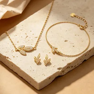 Elegant S925 gold-plated leaf jewelry set with shimmering cubic zirconia on stone.