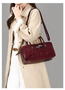 Gros plan d'un sac Boston bordeaux givré vintage avec détail de boucle en métal