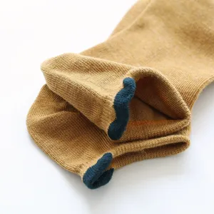 Close-up view of women's knit ankle socks showing soft texture and contrast color heel design.