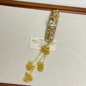Gold rhinestone tassel hairpin detail, elegant shiny crystal hair accessory for women.