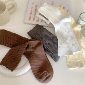 Detailed shot of women's autumn winter distressed cotton slouch socks in multiple colors.