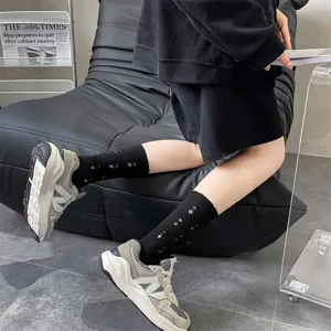 Women's distressed black slouch socks, cozy cotton knit autumn winter casual hosiery detail view.