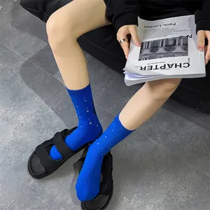 Close-up detail of women solid blue distressed slouch socks paired with black sandals.