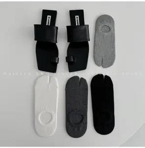 Minimalist split-toe tabi invisible socks paired with stylish leather sandals set.