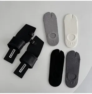 Detailed view of casual split-toe tabi socks in various colors displayed with stylish sandals.