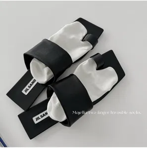 Minimalist split-toe invisible socks with black flat sandal bases for women summer wear.
