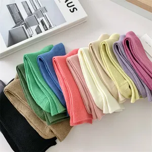 Detailed view of colorful solid candy color cotton women's mid tube socks neatly stacked.