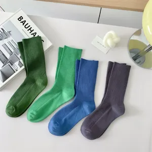 Solid color cotton mid-calf socks detailed view, showing rib-knit texture and vibrant candy colors.