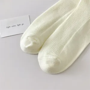 Classic solid color cotton women's mid-tube socks, featuring soft ribbed knit design for daily wear.