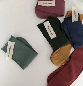 Detailed view of rolled cuff cotton mid tube socks featuring candy colors and soft texture.