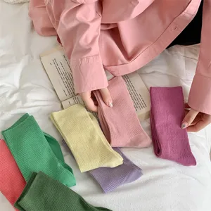 Colorful cotton mid tube socks detail shot showing solid candy colors and ribbed texture.