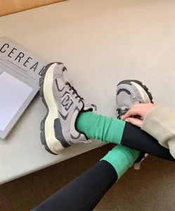 Solid color candy cotton women mid tube socks paired with stylish retro sneakers for daily wear.