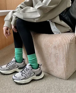 Detailed view of women's solid color cotton mid-tube socks in vibrant green, comfortable fit.