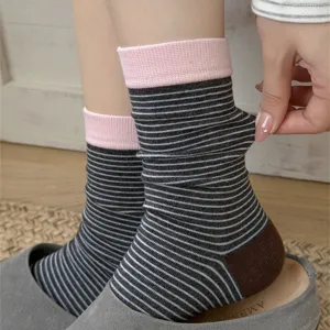 Detail shot of women cotton mid-tube socks with cute stripes and pink cuff design.