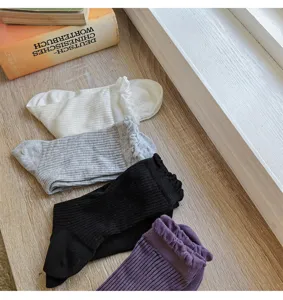 Detailed view of women's cotton lace vertical striped mid-tube socks in solid colors.