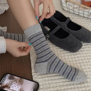 Detail shot of women wearing cozy striped mid-tube cotton socks, lifestyle presentation.