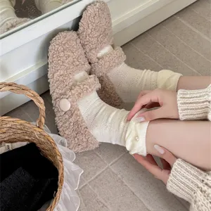 Calzini da donna in maglia con dettaglio di perle e scarpe soffici in primo piano