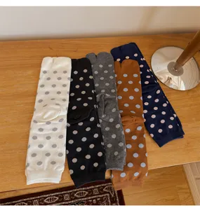 Detailed close-up view of women's autumn winter polka dot cotton split toe mid tube socks.