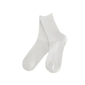 Women's solid white mid-tube socks featuring a cute lace trim and classic ribbed knit design.