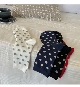 Detailed view of cozy autumn winter polka dot cotton mid calf socks in various colors.