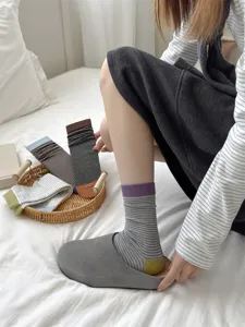 Detailed view of women's Japanese style striped mid-calf cotton slouch socks with contrast heels.