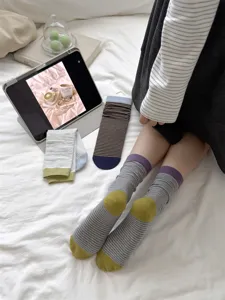 Detail shot of Japanese style cotton striped mid-tube socks with cute color-block heels and cuffs.