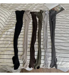 Detailed view of cable knit wool blend tights showing fine 240 needle texture and various colors.