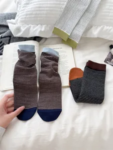 Cozy cotton striped slouch socks for women, featuring contrast color toe and cuff details.