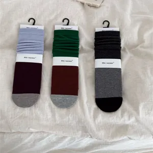 Stylish color-blocked mid-calf stack socks with comfortable cotton knit design for daily wear.