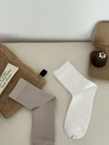 Detailansicht atmungsaktiver Herren-Wadensocken aus Modal in schlichtem Weiß und hellem Grau.