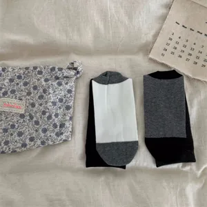 Minimalist black white grey color block mid-tube socks with floral pouch set detail view