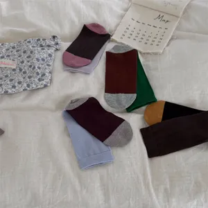 Detailed view of cozy cotton color-blocked mid-calf socks in various stylish autumn shades.