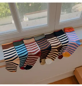 Detailansicht bunter Vintage-Ringelsocken ordentlich auf der Fensterbank gereiht