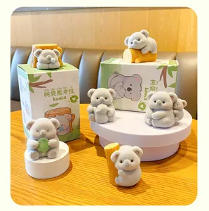 Cute flocked koala figurine set with tree stump design for car dashboard and home decor.