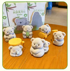 Cute flocked koala figurine detail, soft texture and adorable poses for desk and car decor.