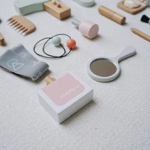 Kids wooden makeup toy set detail view, featuring cute wooden accessories like mirror and comb.