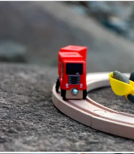 Wooden track train toy detail shot, children's educational toy car on wooden railway rails.
