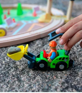 Wooden train track toy detail shot featuring a construction loader vehicle with figure.