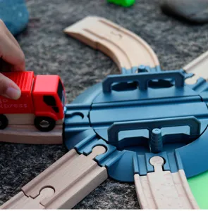 Detailed close-up of wooden train track toy set featuring a turntable and red cargo truck.